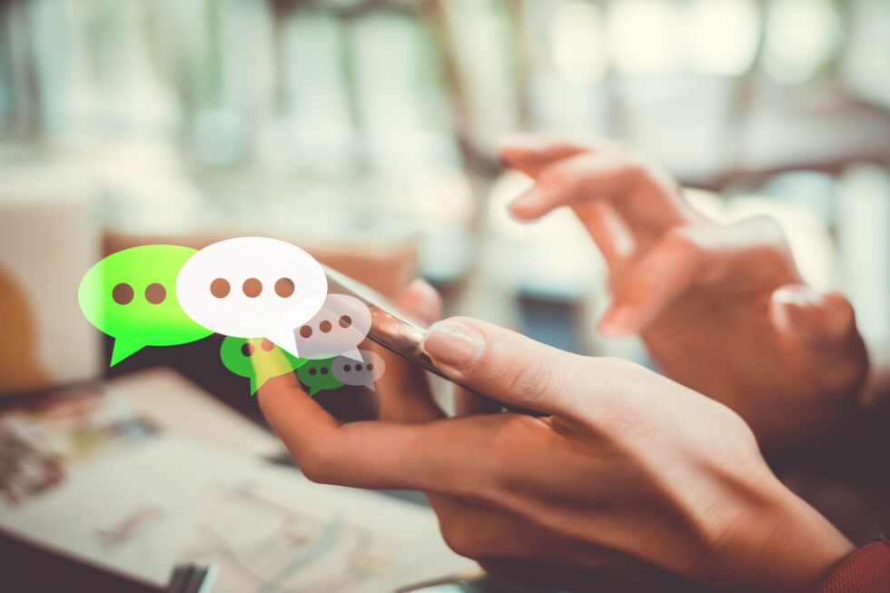 Women hand using smartphone typing and chatting.